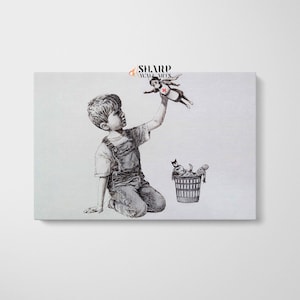May include: A black and white illustration of a young boy kneeling and holding a toy superhero figure in the air. The toy superhero is wearing a red cape and a red cross on their chest. A trash can is in the background with other discarded toys inside.