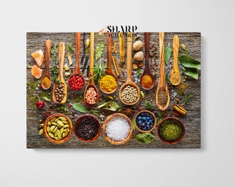 May include: A variety of spices and herbs are arranged in wooden spoons on a rustic wooden background. The spoons are filled with different spices, including red pepper flakes, cumin, turmeric, salt, and peppercorns. There are also small bowls filled with other spices, such as cardamom pods, black peppercorns, and dried herbs.