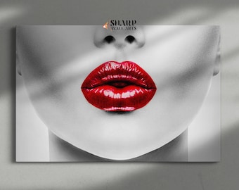May include: A close-up of a woman's face with bright red lips. The background is black and white, highlighting the red lips.