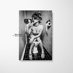 May include: Black and white photo of a person sitting on a toilet in a bathroom, drinking from a bottle. The person is wearing sunglasses and has their hair in rollers.