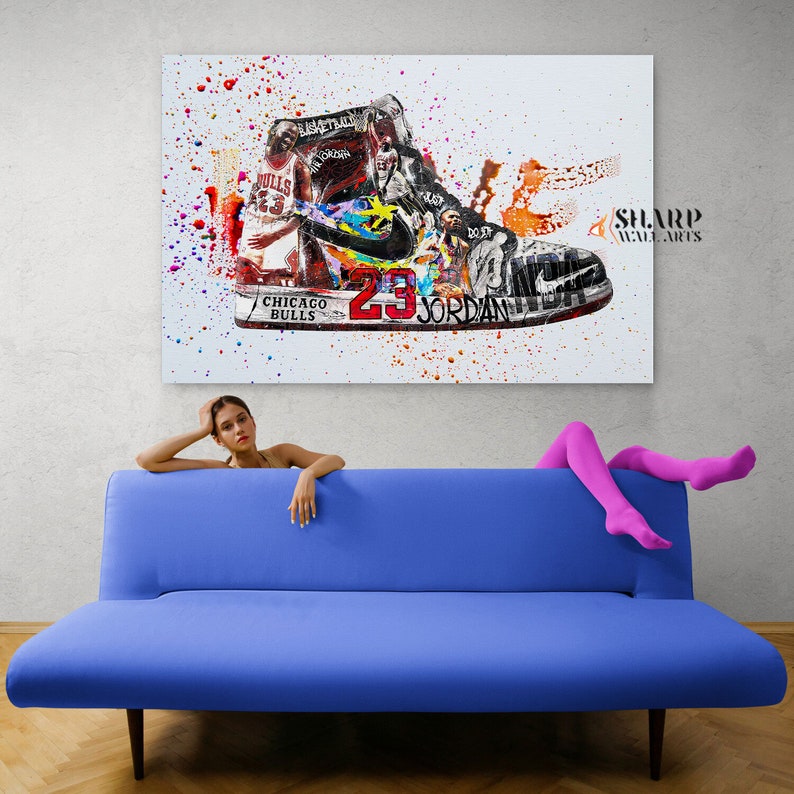 May include: A colorful abstract painting of a basketball shoe with the number 23 and the name "Jordan" on it. The shoe is surrounded by paint splatters and images of basketball players. The painting is titled "SHARP WALL ARTS".
