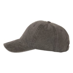 May include: A dark gray baseball cap with a curved brim. The cap is made of a soft, textured fabric.