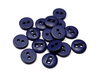May include: A collection of navy blue round buttons with two or four holes. The buttons are made of a matte material and are scattered on a white background. These buttons are suitable for sewing projects.