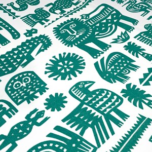 May include: White fabric with a repeating pattern of teal-colored stylized animals and geometric shapes. The design includes lions, birds, crocodiles, and sun-like figures, creating a vibrant and eye-catching textile pattern.