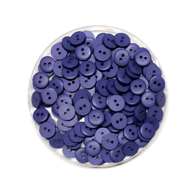 May include: A close-up view of a container filled with a large quantity of small, round, two-hole buttons. The buttons are a deep purple color.