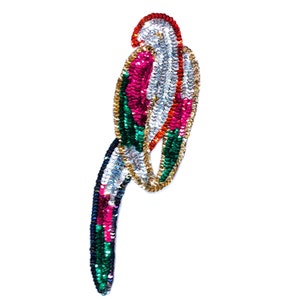 May include: A colorful sequined parrot applique with red, pink, green, gold, and silver sequins. The parrot is perched with its tail feathers trailing down.