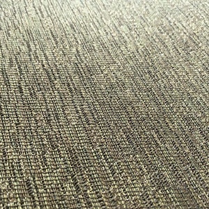 May include: Close-up of a textured fabric with a diagonal weave. The fabric is a light brown colour with a subtle sheen.