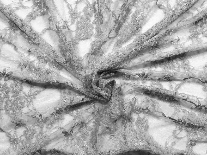 May include: Gray lace fabric with a delicate floral pattern. The fabric is soft and sheer, with a slightly textured surface.