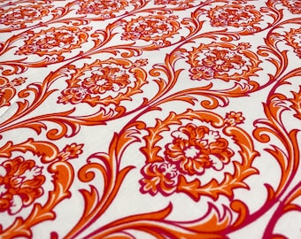 Puede incluir: Una tela blanca con un patrón repetitivo de diseños florales damasco de color naranja y rosa.