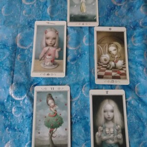 May include: A set of ten tarot cards featuring illustrations of fairies and other whimsical characters. The cards are in a vintage style with a white background and black borders. The cards are numbered with Roman numerals.