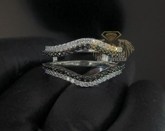 May include: A silver ring enhancer with a wave design featuring black and white diamonds.