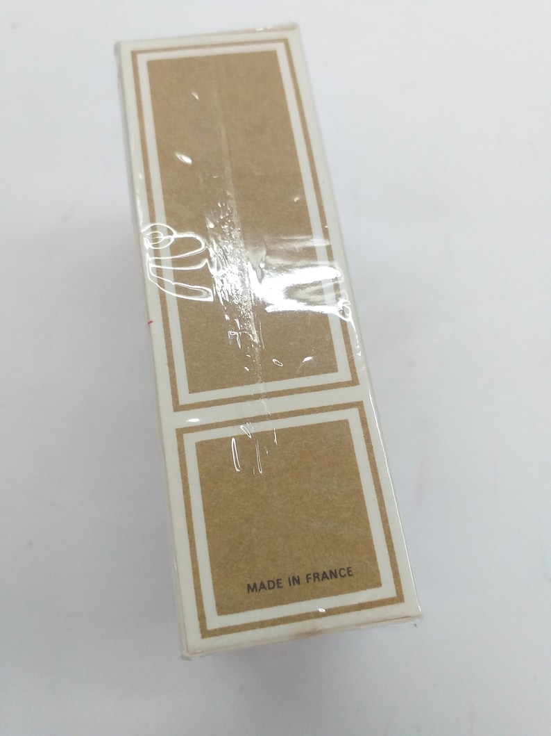 May include: A white cardboard box with a brown label that says "Made in France".