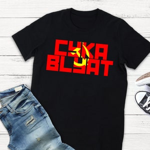 May include: Black t-shirt with a red and yellow graphic that says "CYKA BLYAT".
