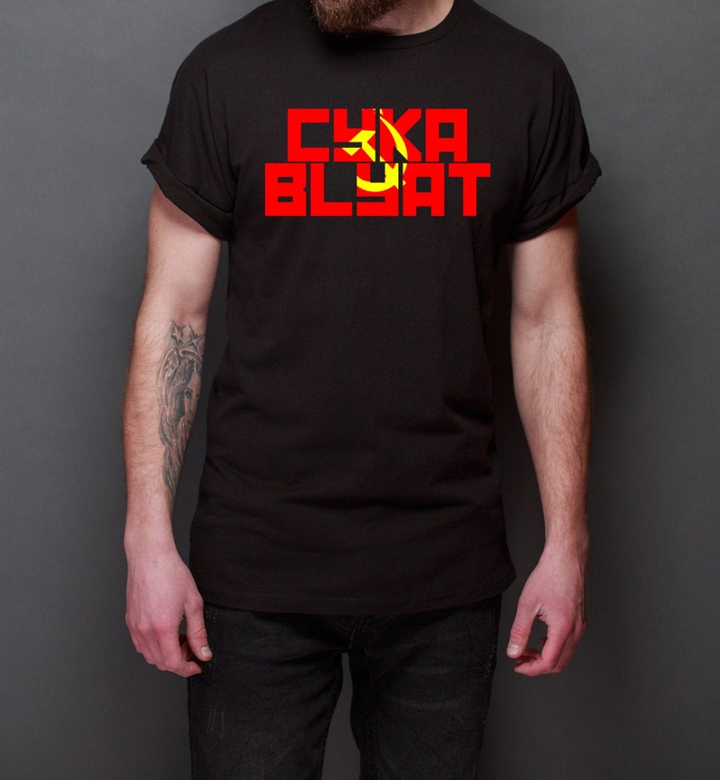 May include: A black t-shirt with a red and yellow hammer and sickle symbol and the text "CYKA BLYAT" in red letters.