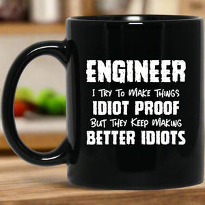 Engineer I Want To Make Things Idiot Proof But They Keep Making Better Idiots Mug | Engineer Gifts | Engineer 11 oz. Black Mug