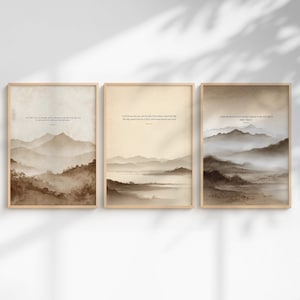 May include: A set of three vertical wall art prints in light wooden frames, each featuring a sepia-toned watercolour landscape of layered mountains and valleys with printed scripture text centred at the top of each individual composition.