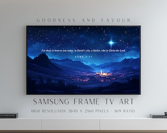 May include: A digital television display showing a night landscape with a glowing star above a town. The text reads: Goodness and Favour, Samsung Frame TV Art, High Resolution 3840 x 2160 Pixels - 16:9 Ratio, For there is born to you today, in David's city, a Savior, who is Christ the Lord. Luke 2:11.
