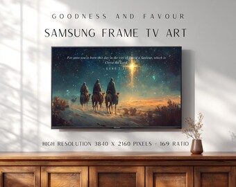 May include: A Samsung Frame TV displaying digital art of three figures on camels traveling toward a bright star in a night sky. The screen shows the text: For unto you is born this day in the city of David a Saviour, which is Christ the Lord. LUKE 2:11.
