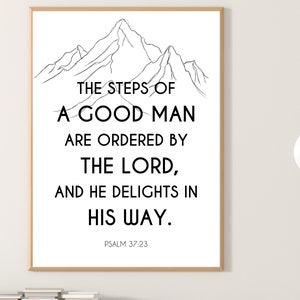 May include: A framed print with a black and white mountain illustration and the text "THE STEPS OF A GOOD MAN ARE ORDERED BY THE LORD, AND HE DELIGHTS IN HIS WAY." The text "PSALM 37:23" is at the bottom of the print.