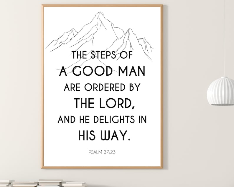 May include: A framed print with a black and white mountain illustration and the text "THE STEPS OF A GOOD MAN ARE ORDERED BY THE LORD, AND HE DELIGHTS IN HIS WAY." The text "PSALM 37:23" is at the bottom of the print.