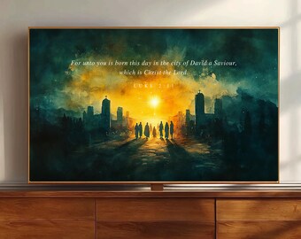 May include: A rectangular wall art print in a thin gold frame featuring a watercolor-style landscape of a city at sunset with silhouettes of people walking toward a bright light. The text reads: For unto you is born this day in the city of David a Saviour, which is Christ the Lord. LUKE 2:11.