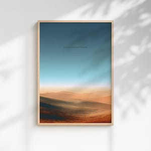 May include: A framed landscape art print featuring a gradient sky of blue and orange hues above rolling hills. The artwork includes the text "O satisfy us early with Thy mercy" and "Psalm 90:14" in a minimalist font.