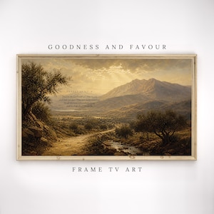 May include: A framed landscape art print with a warm color palette. The artwork depicts a path winding through a valley, leading towards a mountain range. The text "GOODNESS AND FAVOUR" and "FRAME TV ART" are at the top and bottom.