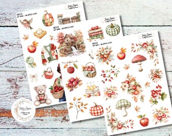 May include: Three sheets of decorative stickers with an autumn theme. The stickers feature watercolor illustrations of apples, pumpkins, leaves, and a teddy bear. The color palette includes shades of red, orange, green, and brown.