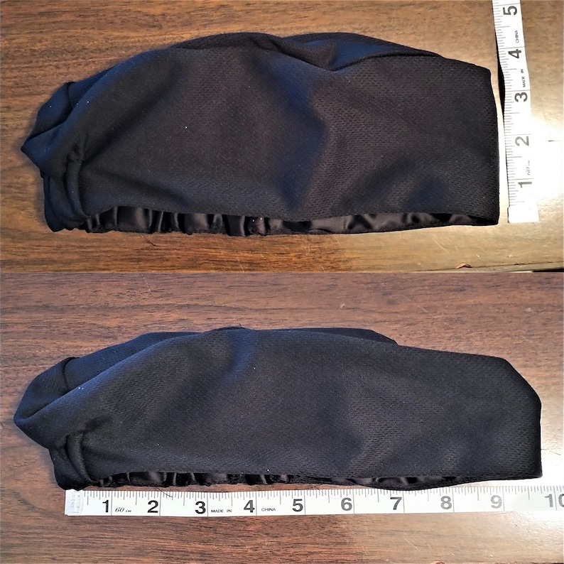 K&ouml;nnte beinhalten: Schwarze Schlafmaske aus Stoff mit Satinbesatz. Die Maske ist 23 cm lang und 10 cm breit.