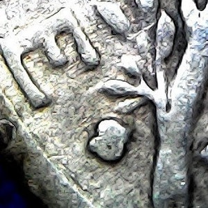 May include: Close-up of a silver coin with detailed relief. The coin's surface shows intricate designs and textures, with visible lettering and a central emblem. The coin is set against a dark blue background.