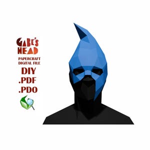 May include: A low-poly blue mask with a pointed top, covering the face and head. The mask is part of a papercraft digital file, with the text "Gabe's Head" and "DIY .PDF .PDO" visible. A green icon with a magnifying glass is also present.