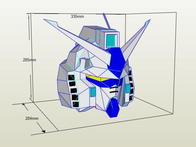 Puede incluir: Un modelo de papel de una cabeza de robot, en blanco y azul, con una franja amarilla sobre los ojos. El modelo mide 335 mm de ancho, 285 mm de alto y 284 mm de profundidad.