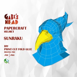 Puede incluir: Un casco de papel-craft azul y amarillo con el texto "GABE'S HEAD" y "SUNRAKU" en rojo. El texto "PAPERCRAFT HELMET" también está en rojo. El texto "DIY PRINT CUT FOLD GLUE" está en rojo. El texto ".PDF | .PDO" está en negro. El texto "DIGITAL FILE" está en negro.