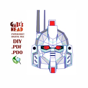 Puede incluir: Un modelo de papel de cabeza de robot blanco y azul con ojos rojos. El modelo está etiquetado como "Gabe's Head" y "DIY .PDF .PDO".