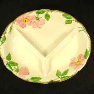 May include: A white ceramic divided serving dish with a floral design. The dish has three sections and features pink roses with green leaves.