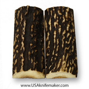 May include: Two dark brown and light brown stag antler knife scales. The scales are approximately 4 inches long and 1 inch wide. The scales have a natural, organic look and feel.