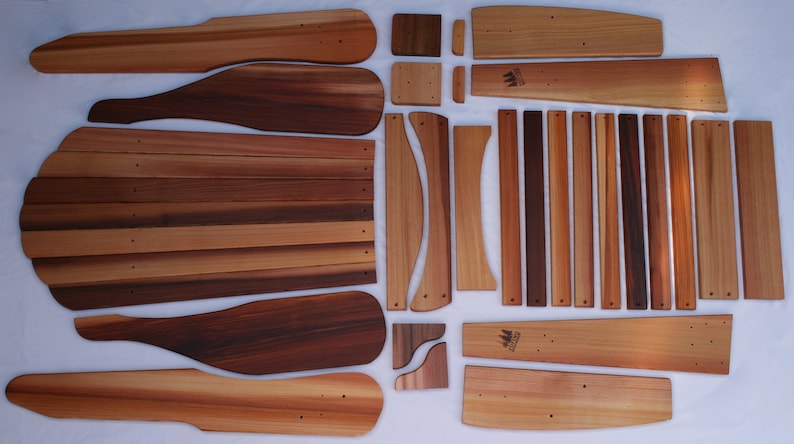 May include: A set of wooden chair parts, including the back, seat, and legs. The pieces are made of cedar wood and are ready to be assembled.