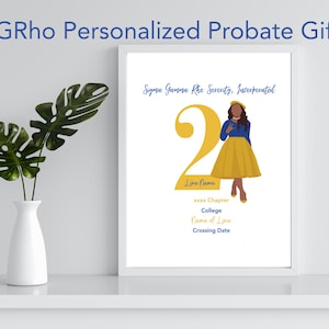 May include: A personalized printable probate gift for a member of Sigma Gamma Rho Sorority, Inc. The design features a yellow number 2, a woman in a blue dress and yellow skirt, and the text "Sigma Gamma Rho Sorority, Incorporated." The text "Line Name, xxx Chapter, College, Line, Crossing Date" is also included.