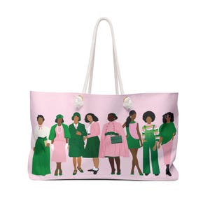 May include: Pink tote bag with a white rope handle. The bag features a graphic of eight women in green and pink outfits. The women are in various poses, and the bag has a light pink background.