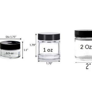 May include: Three glass jars with black lids and labels indicating their size in ounces. The jars are 0.5 oz, 1 oz, and 2 oz. The 2 oz jar also indicates it holds 60 ml.