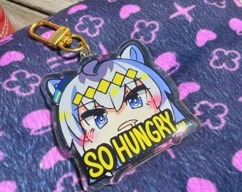 Puede incluir: Un llavero acrílico transparente con un personaje de dibujos animados de anime. El personaje tiene cabello azul y blanco, ojos azules y una diadema amarilla y blanca. El llavero tiene un cierre dorado y el texto "SO HUNGRY" en amarillo.