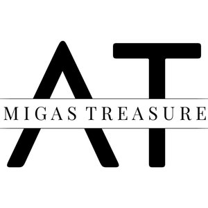 May include: Black and white logo with the letters "AT" in a stylized font. The text "Amigas Treasures" appears below the letters.