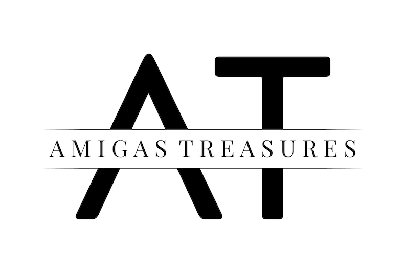 May include: Black and white logo with the letters "AT" in a stylized font. The text "Amigas Treasures" appears below the letters.