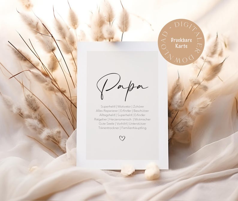 May include: A white card with the word "Papa" in elegant script. Below, a list of German words describes a father's qualities. A small heart is at the bottom. The card is surrounded by dried plants and soft fabric.