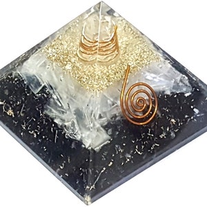 May include: Black, white, and gold layered crystal pyramid with a copper wire spiral on top.