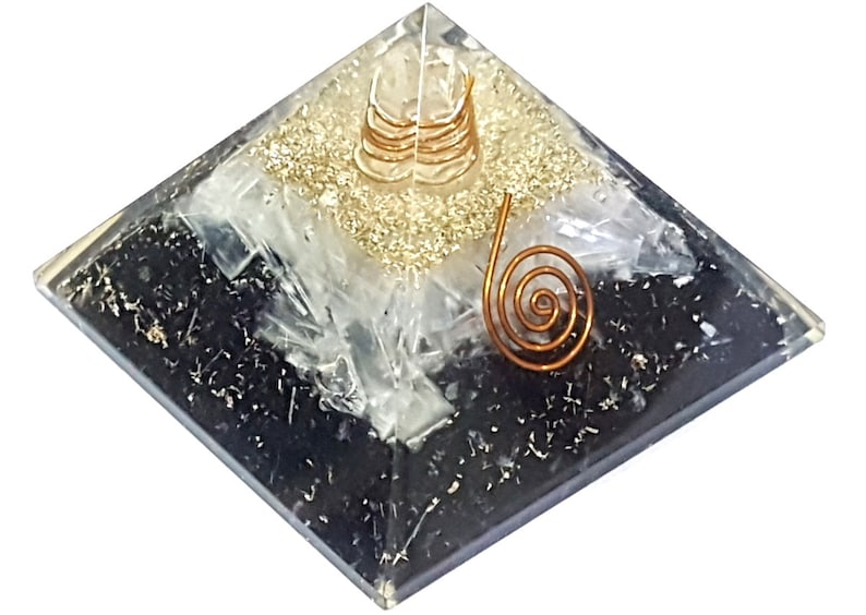 May include: Black, white, and gold layered crystal pyramid with a copper wire spiral on top.