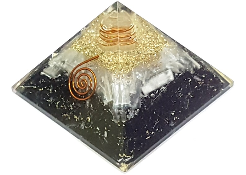May include: A black, white, and gold crystal pyramid with a copper wire spiral on top. The pyramid is made of clear resin and has a layered design.