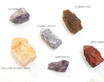 May include: Assortment of polished gemstones, including amethyst, carnelian, fluorite, lapis lazuli, red jasper, and yellow aventurine.