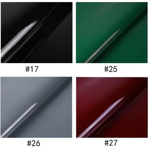 Puede incluir: Cuatro cuadrados brillantes de color, cada uno con una l&iacute;nea diagonal a trav&eacute;s de la superficie. Los colores son negro, verde, gris y burdeos. Los cuadrados est&aacute;n etiquetados con los n&uacute;meros 17, 25, 26 y 27.