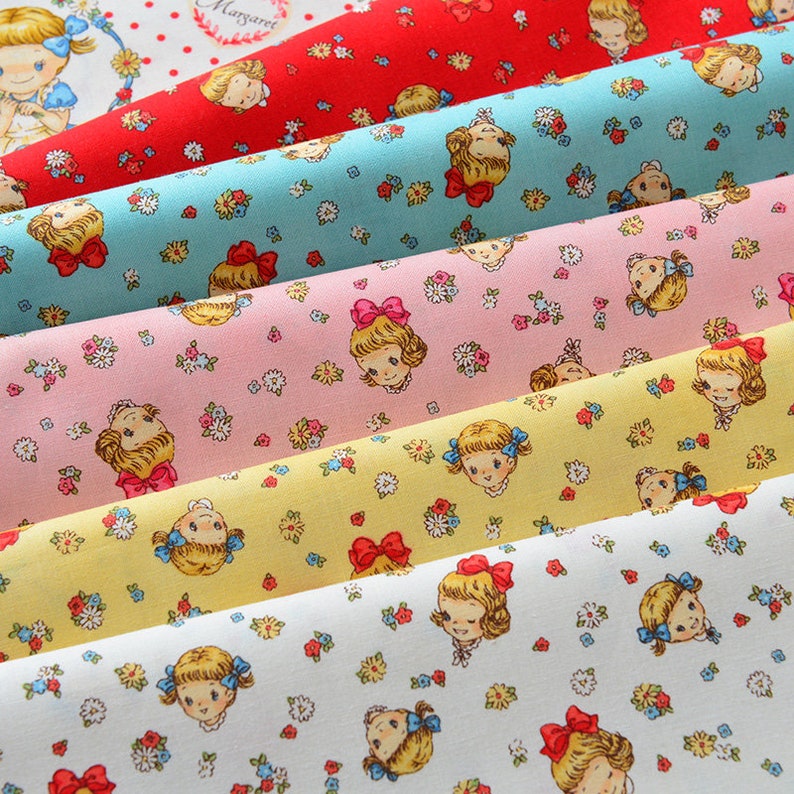 May include: Five rolls of fabric with a repeating pattern of girls with bows in their hair and small flowers. The fabric colors are red, blue, pink, yellow, and white.